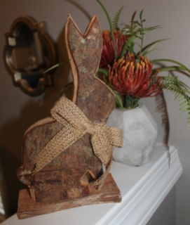 wooden bunny Easter decor place with orange floral arrangement